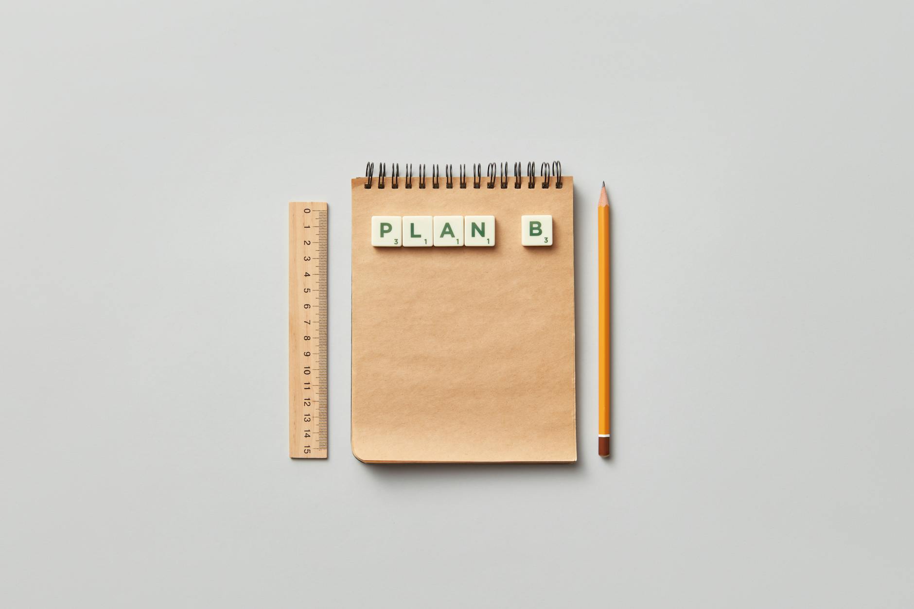 Design planning materials including a notepad and ruler on a clean workspace